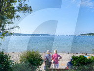 Senior Couple By The Lake In Summer