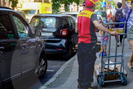 DHL Courier Delivering Packages With Electric Van