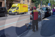 DHL Courier Delivering Packages With Electric Van