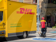 DHL Courier Delivering Packages With Electric Van