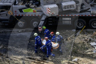 Rescuers Evacuate The Body Of A Victim During Search And Rescue Operations At The Site Of A Russian Missile Strike On Kyiv