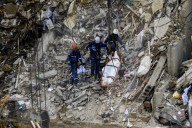 Rescuers Evacuate The Body Of A Victim During Search And Rescue Operations At The Site Of A Russian Missile Strike On Kyiv