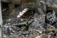 Rescuers Evacuate The Body Of A Victim During Search And Rescue Operations At The Site Of A Russian Missile Strike On Kyiv