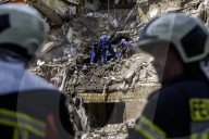 Rescuers Evacuate The Body Of A Victim During Search And Rescue Operations At The Site Of A Russian Missile Strike On Kyiv