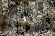 Rescuers Evacuate The Body Of A Victim During Search And Rescue Operations At The Site Of A Russian Missile Strike On Kyiv