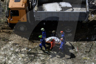 Rescuers Evacuate The Body Of A Victim During Search And Rescue Operations At The Site Of A Russian Missile Strike On Kyiv