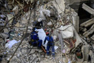 Rescuers Evacuate The Body Of A Victim During Search And Rescue Operations At The Site Of A Russian Missile Strike On Kyiv