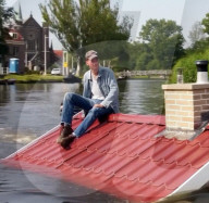 Roofline-shaped boat highights rising sea levels
