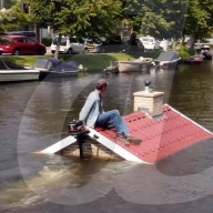 Roofline-shaped boat highights rising sea levels