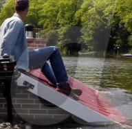 Roofline-shaped boat highights rising sea levels