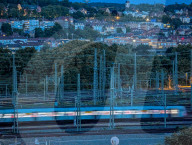 German Passenger Train Passing At Dusk