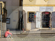 Man Sit Near A Souvenir Shop In Prague’s Old Town