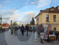 Tourists And Street Artists On Charles Bridge In Prague