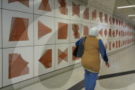 Woman Walking Through Subway Tunnel