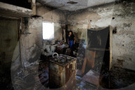 Freed Israeli hostage revisits her charred home