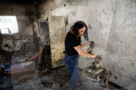 Freed Israeli hostage revisits her charred home