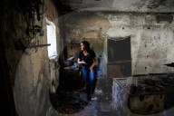 Freed Israeli hostage revisits her charred home