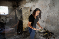 Freed Israeli hostage revisits her charred home