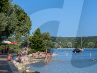 People Swimming In Bavarian Lake Starnberg During Summer Heat