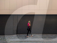Woman Using Smartphone While Walking