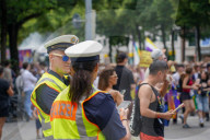 Police Officer At Pride Parade Wears A Pride Rainbow Water Tattoo On Cheek