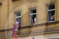 Youth Watching Pride Parade With Rainbow Flag
