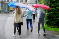 People Walk With Umbrellas In The Summer Rain
