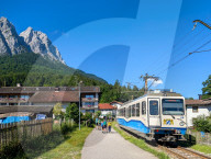 Family Hikers At Hammersbach Train Station In The Bavarian Alps