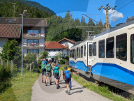 Family Hikers At Hammersbach Train Station In The Bavarian Alps