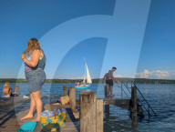 People Relaxing On A Jetty