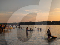 People Enjoy Summer Sunset At Lake