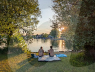 Couple Enjoying Sunset By The Lake