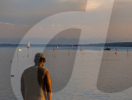 Man Alone By Lake At Sunset