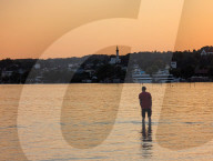 Man Enjoying The Sunset By Lake