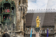 Tourists Watch The Carillon In The Tower Of The New Town Hall In Munich