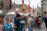 Tourists Watch The Carillon In The Tower Of The New Town Hall In Munich