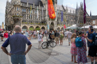 Tourists Watch The Carillon In The Tower Of The New Town Hall In Munich
