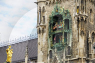 Tourists Watch The Carillon In The Tower Of The New Town Hall In Munich