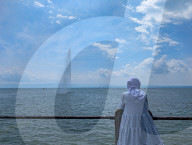 Woman Observing Water Fountain At Lake