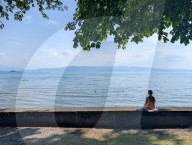 People Sitting Alone By A Lake
