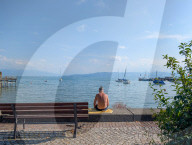 People Sitting Alone By A Lake