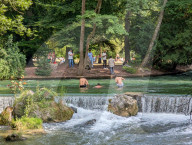 People Relaxing In The English Garden In Munich