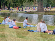 People Relaxing In The English Garden In Munich