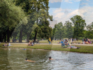 People Relaxing In The English Garden In Munich