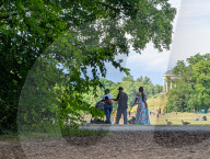 People Relaxing In The English Garden In Munich