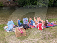 People Relaxing In The English Garden In Munich