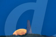 Full Buck Moon Rises Behind Torre del Serpe in Otranto, Italy