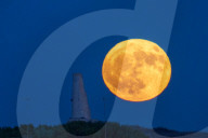 Full Buck Moon Rises Behind Torre del Serpe in Otranto, Italy