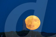 Full Buck Moon Rises Behind Torre del Serpe in Otranto, Italy