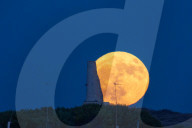 Full Buck Moon Rises Behind Torre del Serpe in Otranto, Italy